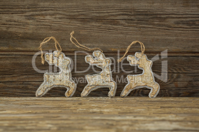 Reindeer decorations against wooden plank