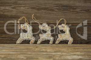 Reindeer decorations against wooden plank