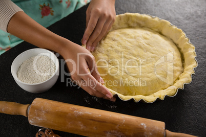 Woman pressing tart dough on mold