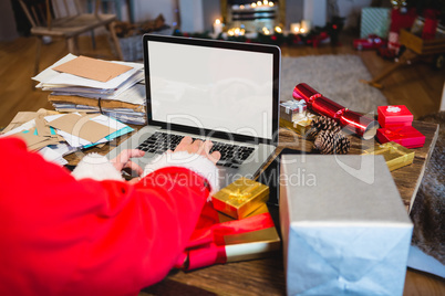 Santa Claus using laptop