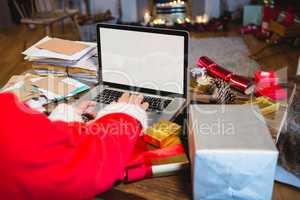 Santa Claus using laptop