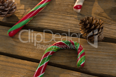 Close up of candy canes and pine cones on table