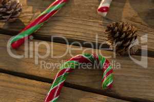 Close up of candy canes and pine cones on table