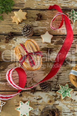 Cookies and christmas decoration on wooden plank