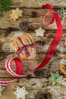 Cookies and christmas decoration on wooden plank