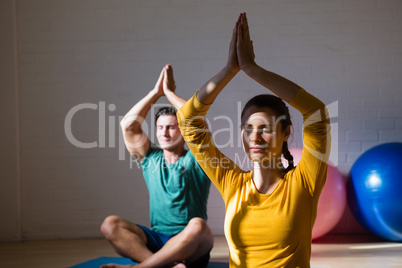 People meditating in prayer position at club