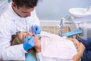 High angle view of dentist examining patient