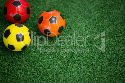 Footballs on artificial grass