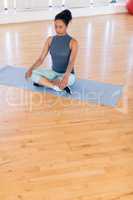 Woman performing yoga in the gym