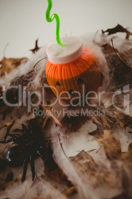 Drink in jack o lantern container with decorations