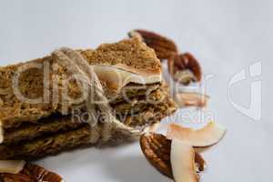 Granola bar tied with string on white background