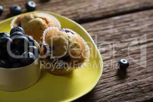 Blueberries and muffins on plate