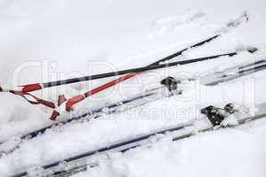 Skis and ski poles in the snow.