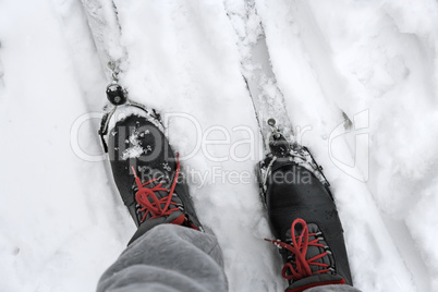 Ski boots and skis in the snow.