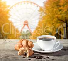 Cup of coffee with croissants