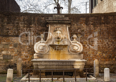 frontal view of the ancient Fountain of the mask (fontana del ma