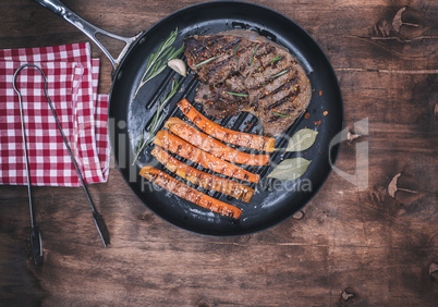 fried beef stack and fried carrots on a round frying pan