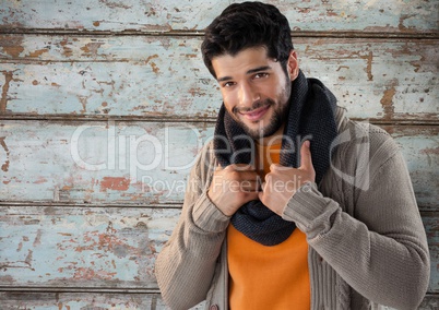 Man against wood with warm scarf and jumper