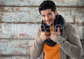 Man against wood with warm scarf and jumper