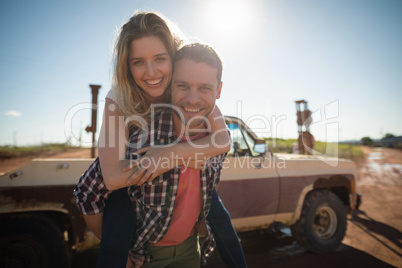 Man giving a piggyback ride to woman