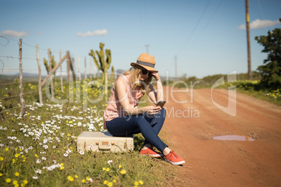 Woman using mobile phone on a sunny day