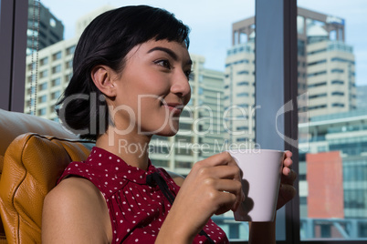 Female executive having coffee