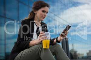 Female executive using mobile phone