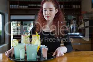 Beautiful waitress holding drinks