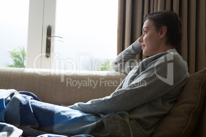 Woman relaxing on sofa in living room