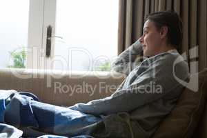 Woman relaxing on sofa in living room