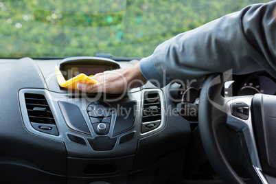 Auto service staff cleaning car interior