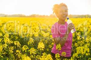 Mixed Race African American Girl Teenager Drinking Water at Suns