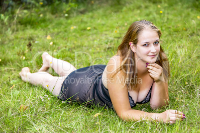 Woman is lying in the grass