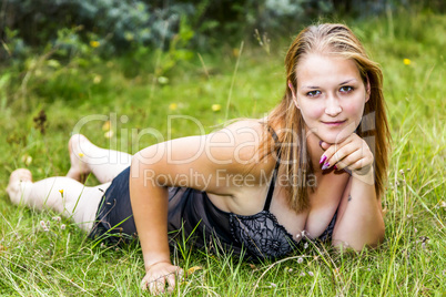 Woman is lying in the grass