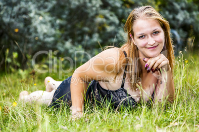 Woman is lying in the grass