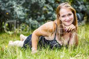 Woman is lying in the grass