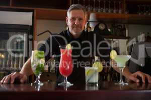 Waiter standing at bar counter