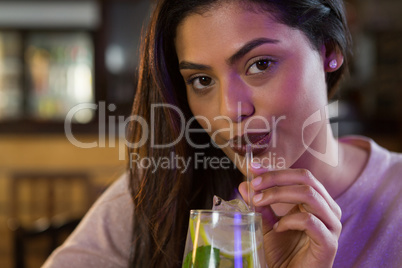 Beautiful woman sipping on a drink