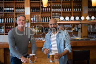 Friends watching football match while having beer in the restaurant