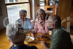 Happy friends having drinks in bar