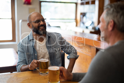 Two men having glass of bear at in restaurant