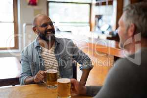 Two men having glass of bear at in restaurant