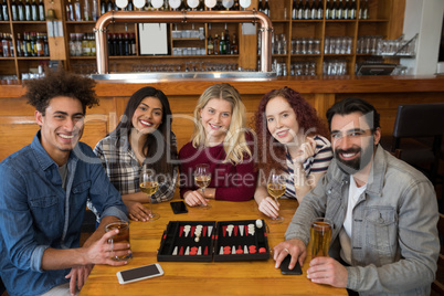 Friends having glass of beer in bar