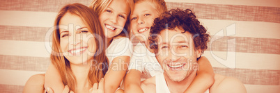 Portrait of happy family on bed