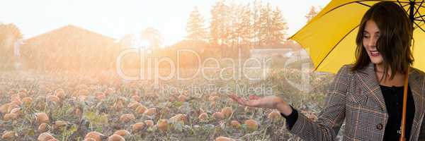 Woman in Autumn with apple in bright pumpkin field