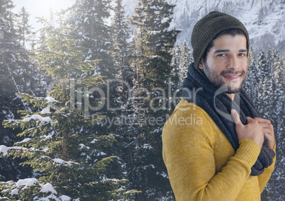 Man with hat and scarf in snow forest