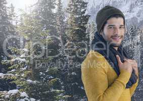 Man with hat and scarf in snow forest