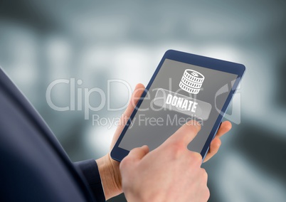 Person holding tablet with donate buttonf and money for charity