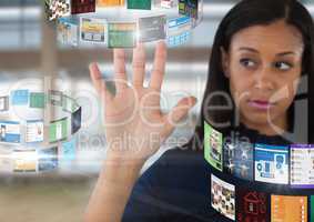 Screens rotating interface and Businesswoman opening hand in front of windows in large hall