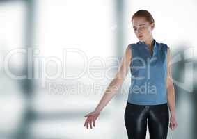Businesswoman touching air in front of blurry office